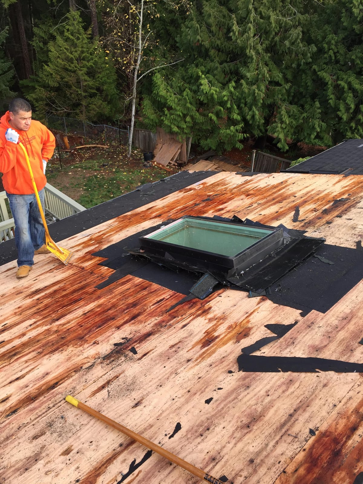 A RoofWorks Northwest crew tearing a failed roof down to the deck